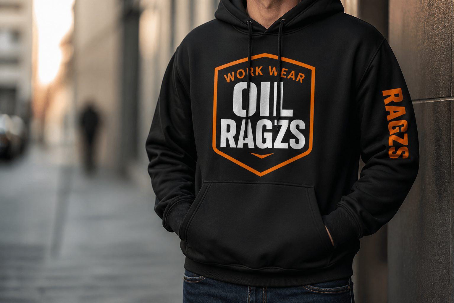 Man wearing black Oil Ragzs hoodie on a city street