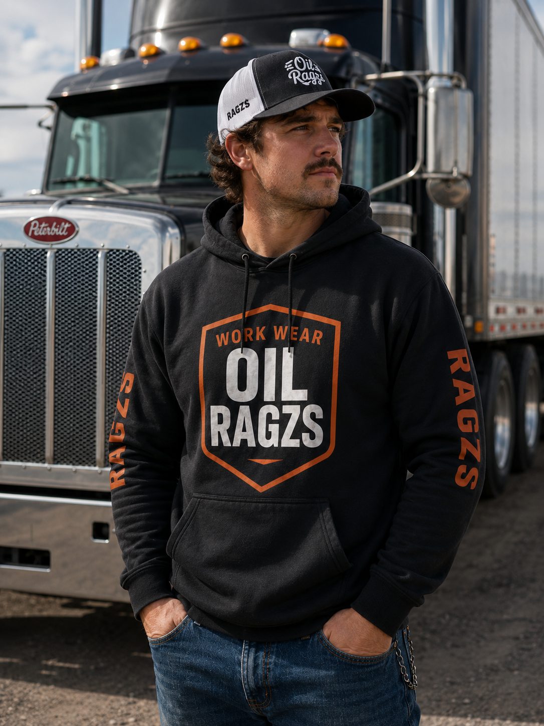 Truck driver wearing Oil Ragzs hoodie in front of a semi truck